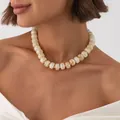 Bohemian swirled resin bead necklace with gold stainless steel spacers on model - Beige Necklace (7957)