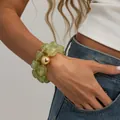 Vintage green marbled resin elastic bracelet with a large gold metal bead accent - Gold + Grass Green Stone