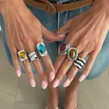 Close-up of bohemian style vintage rings with colorful gemstones and silver finish - French Vintage (7454) / Antique Silver