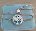 Close-up of rose gold tree of life aromatherapy locket bracelet on velvet box - Tree / 25mm Rose Gold (10 Cotton Pads)