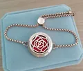 Detailed view of rose gold aromatherapy diffuser bracelet with a 25mm floral pattern locket - Camellia / 25mm Rose Gold (10 Cotton Pads)