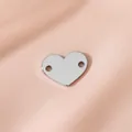 Polished stainless steel heart-shaped jewelry charm with double holes on pink satin - Steel