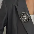 Elegant silver sunburst coral brooch pinned on a professional grey blazer lapel detail - Irregular Coral Sunburst (0402) / White K/Silver