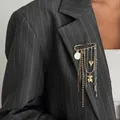 Elegant gold safety pin brooch with heart and teddy bear charms on a grey pinstripe blazer - Bear Pendant Style (0377) / Multicolor