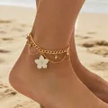 Elegant gold layered chain anklet featuring a white flower charm on a sunny beach background. - White Flower Style (0932) / Gold+White