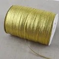 Close-up of a spool of 4mm gold glitter ribbon for gift wrapping and DIY crafts. - 20 Yards/Pack / Gold