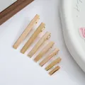 Detail view of gold metal alligator hair clips in seven different lengths for DIY - 2cm (6mm Width) / Gold