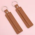 Set of two rectangular brown leather keychains with silver metal rings on pink backdrop - 15cm 1 Piece/Pack / Tan