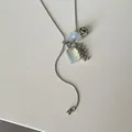 Close-up of long adjustable snake chain necklace with Dalmatian stone and opalite charms - AB Color