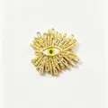 Detail of a gold sunburst evil eye brooch with crystal accents on white background. - Radiating Ray Evil Eye Style (Y1)