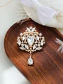 Close-up of vintage crystal rhinestone brooch with teardrop pendant on wood tray. - Bright Gold Clear Rhinestone Style (A17-37)