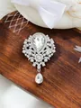 Macro view of vintage silver crystal brooch with large teardrop pendant and rhinestones. - Silver/White