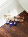Detailed macro shot of an evil eye and Hamsa hand brooch with pearls on wood - Evil Eye Hamsa Hand Style (my2) / White Artificial Pearl
