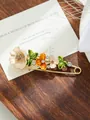 Close-up view of elegant tulip enamel brooch with rhinestones on a gold safety pin - Off-white and Orange Tulip Style (A2-12)
