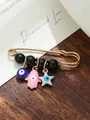 Detailed close-up of gold safety pin brooch with blue evil eye and pink Hamsa hand charms - Blue Pink White Multi-Element Style (my6) / Black Bead