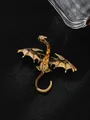 Macro detail of a vintage alloy dragon brooch with golden finish and amber rhinestones. - Antique Gold