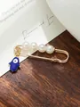 Detail showing gold-tone safety pin brooch with white pearls and blue evil eye hamsa charm. - Blue Hamsa Pearl Decor Style (my10)