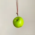 Vista detallada de un colgante de manzana verde realista en un cordón de cuero marrón - Manzana Verde / L