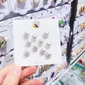 Detail view showing a set of ten white pearl anti-exposure pins on a Korean jewelry card - All White 10 Pieces/Pack