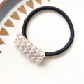 Elegant black elastic hair tie featuring a rectangular cluster of white pearls and gold accents - Rectangle Pearl Elastic