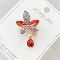 Floral brooch with red and clear rhinestones and teardrop pendant on jewelry card - Red Flower Rhinestone Style (A10-67)