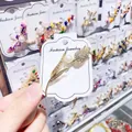 Detailed view of a gold tulip brooch with sparkling rhinestones and a white pearl. - Tulip Style