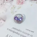 Eleganter silberner runder Broschenstecker mit birnenförmigen lila Kristallen für Damen - Rund / Lila