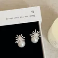 Close-up of fireworks-shaped pearl earrings in a white gift box with elegant lighting - Style 28 Earrings