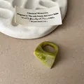 Macro view of a unique geometric green marbled resin ring with elegant swirl pattern - Faceted Smudge Ring / Green