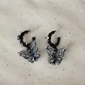 Detailed close-up of dark liquid resin butterfly earrings with clear crystal studs - Butterfly Style (O2-36) / Gold Plated 925 Sterling Silver Earring Post / Black/Transparent/Gold