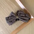 Macro view showing the texture of the brown checkered bow on a hair banana clip - Coffee Plaid Bow Banana Clip