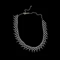 Detailed view of an intricate silver-tone mesh net lace choker necklace on a black background. - Silver