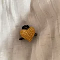 Detailed macro shot of yellow polka dot heart-shaped hair claw clip on fabric. - Hair Claw / Yellow
