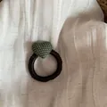 Close-up detail of high-elasticity hair tie with green polka dot heart on linen - Hair Tie / Green
