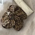 Close-up detail of a Korean style leopard print scrunchie with a button and Blazing tag - Scrunchie / Leopard Coffee Border