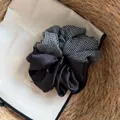 Detailed view of a black satin and grid pattern oversized Korean style hair scrunchie - Gray Plaid Patchwork