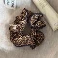 Close-up of leopard print scrunchie with navy blue piping and decorative button - Scrunchie / Leopard Navy Border