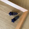 Close-up of vintage checkered star hair clips on a wooden tray - Blue Star Oval Hair Clip