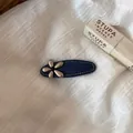 Detail view of denim blue hair clip with a silver metallic flower on white linen - Denim Blue Duckbill Clip (1#) / Silver Flower Style