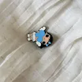 Detailed macro view of a cute cartoon girl accessory with blue heart and ribbon - 16# White Winged Dress Girl