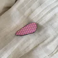 Detailed macro view of a pink acetate hair clip with yellow polka dots on linen fabric - 1# Pink Waterdrop Clip