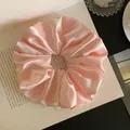 Close-up macro detail of a soft pink satin hair scrunchie with a handmade tag label - L / Pink