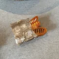 Detailed view of French bread bag acetate hair claw clip with pearlescent finish - Bread Bag Shape / Yellow