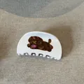 Detail shot of a white acetic acid hair claw clip with a cute brown poodle design. - Hair Claw / White Shell Coffee Dog