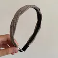 Detailed close-up of a brown plaid twist headband with textured fabric - Milky White Black Striped