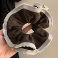 Detailed close-up view of a unique brown scrunchie with white zipper trim - Large Zipper Scrunchie