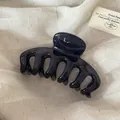 Detailed view of a glossy dark blue Korean style large hair claw clip on linen fabric. - Transparent Blue