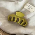 Macro view of minimalist large olive green glossy hair claw clip on linen fabric - Solid Green