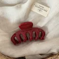 Detailed view of a large burgundy dragon bone hair claw clip on a soft linen background. - Solid Wine Red