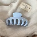 Detailed close-up of a minimalist light blue large claw clip for elegant hair styling - Solid Blue